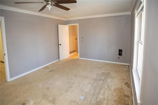 carpeted empty room featuring ornamental molding and ceiling fan