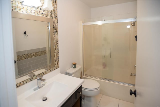 full bathroom featuring toilet, shower / bath combination with glass door, tile floors, and vanity