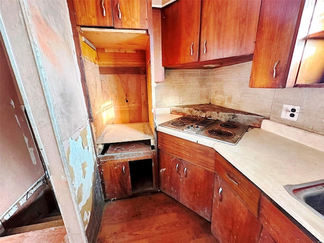 kitchen featuring backsplash, dark wood-type flooring, and electric stovetop