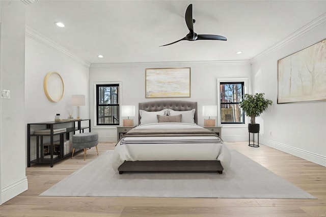 bedroom with ceiling fan, crown molding, and light wood-type flooring