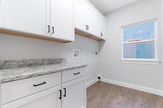 laundry area featuring light hardwood / wood-style flooring, cabinets, electric dryer hookup, and washer hookup