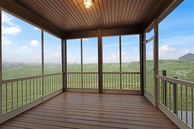 unfurnished sunroom featuring wood ceiling and a healthy amount of sunlight