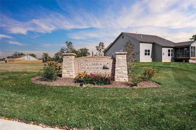 community / neighborhood sign with a yard