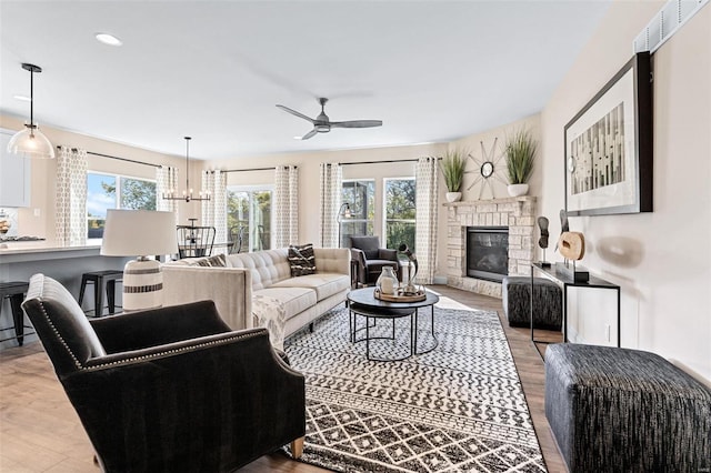 living room featuring plenty of natural light, a fireplace, and light hardwood / wood-style flooring