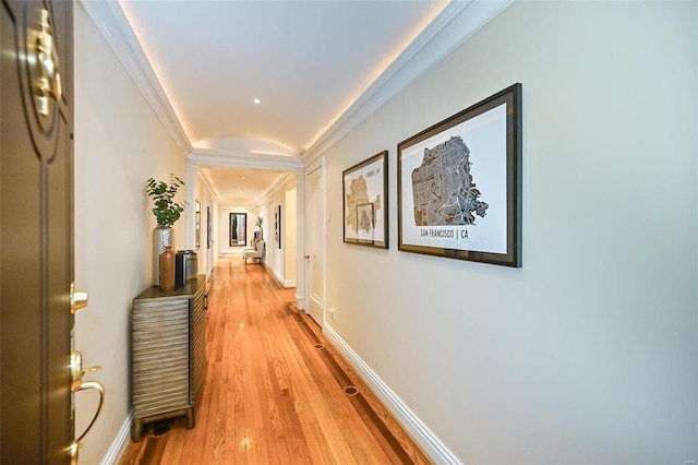 hallway featuring light hardwood / wood-style floors and ornamental molding