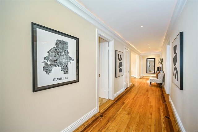 corridor featuring wood-type flooring and crown molding