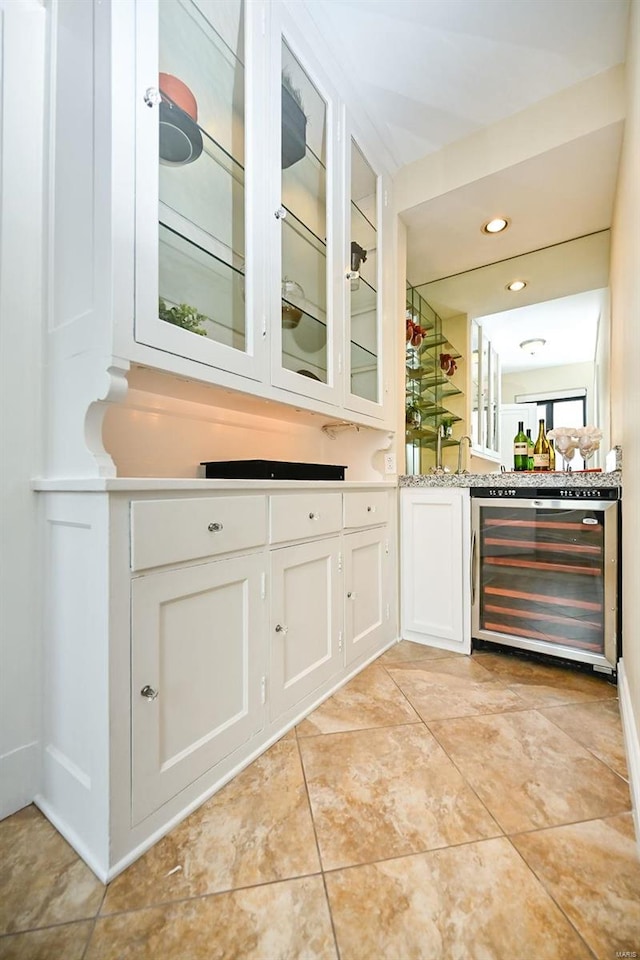 bar featuring white cabinetry and beverage cooler