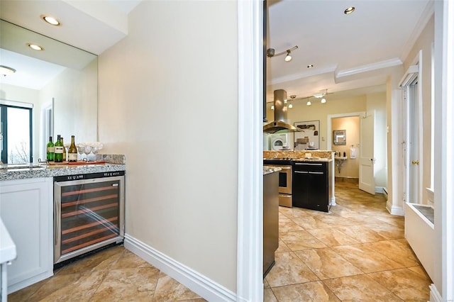 bar featuring light stone counters, crown molding, white cabinets, stainless steel stove, and wine cooler