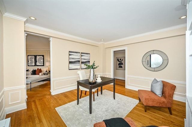 office space featuring wood-type flooring and ornamental molding