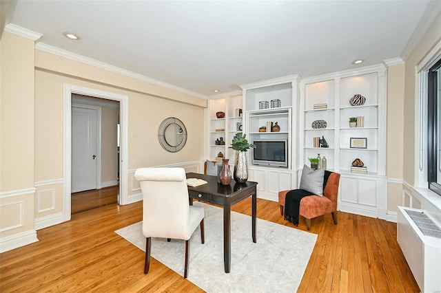 dining room featuring built in shelves, light wood-type flooring, crown molding, and radiator