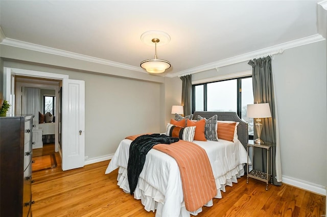 bedroom with light wood-type flooring and ornamental molding