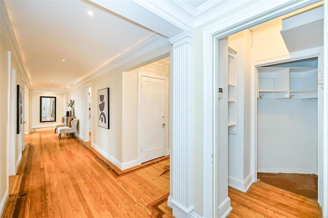 corridor featuring light wood-type flooring and ornamental molding