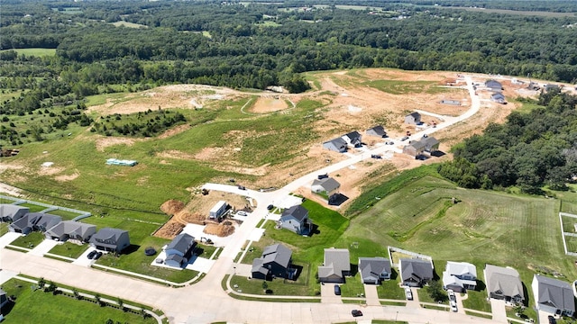 drone / aerial view with a residential view and a view of trees