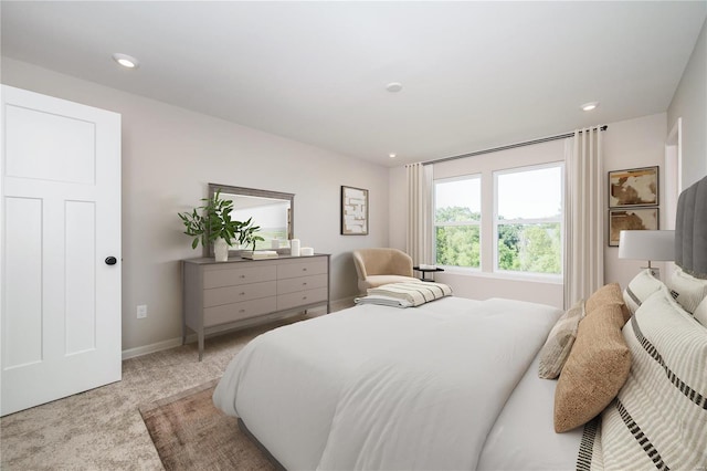 bedroom with recessed lighting, light colored carpet, and baseboards