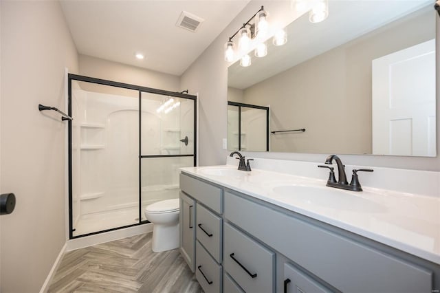 full bath featuring a stall shower, visible vents, and a sink