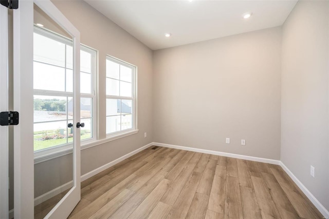 spare room with light wood-type flooring, baseboards, and recessed lighting