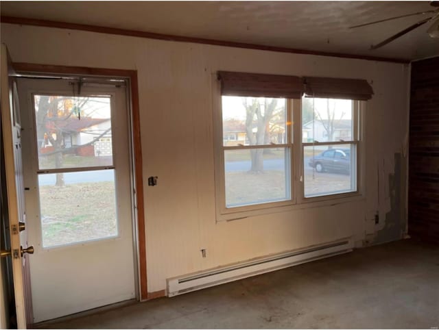 doorway featuring ceiling fan and a baseboard heating unit