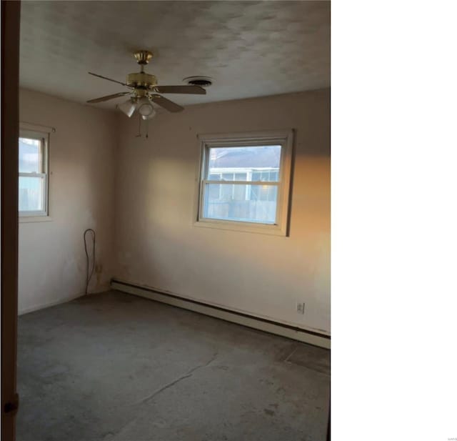 carpeted empty room featuring a baseboard radiator and ceiling fan