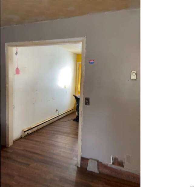 hallway featuring dark hardwood / wood-style flooring and a baseboard heating unit