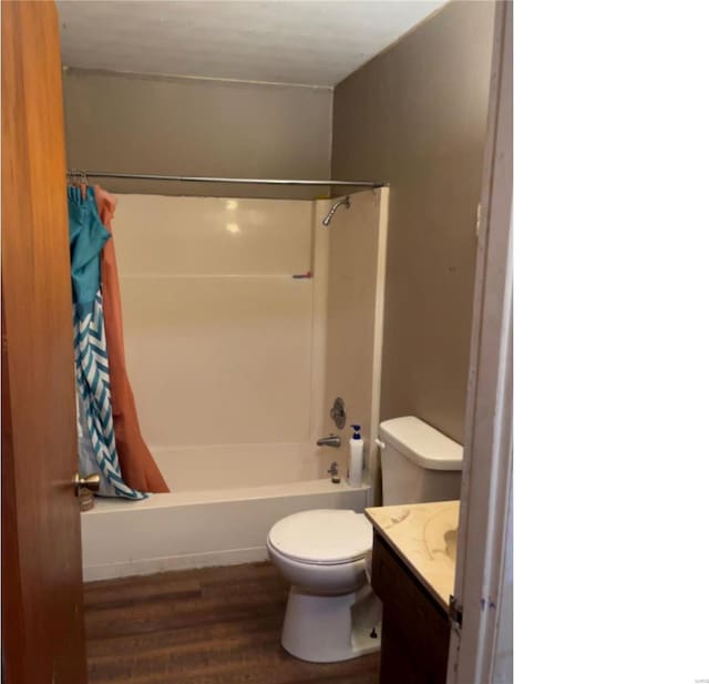 full bathroom featuring toilet, wood-type flooring, shower / tub combo with curtain, and vanity