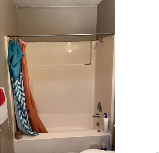 bathroom with shower / bathtub combination with curtain