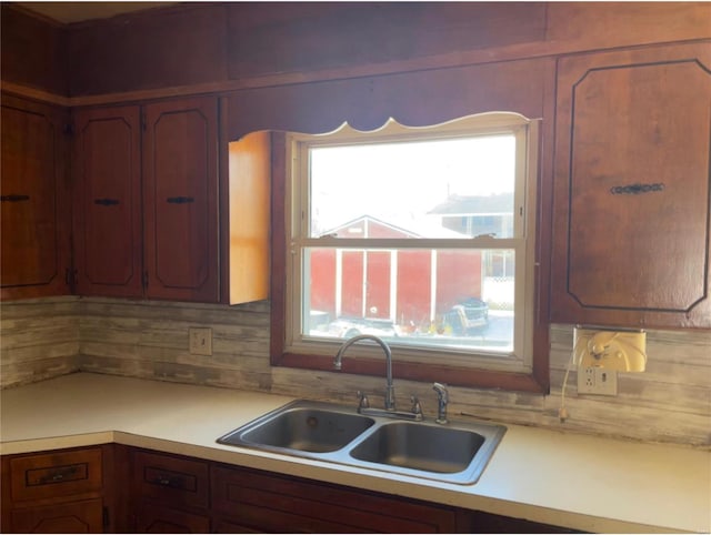 kitchen featuring tasteful backsplash and sink