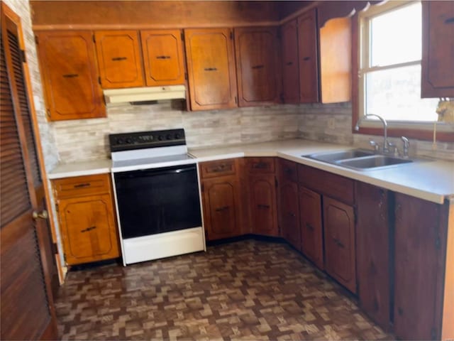 kitchen featuring white range with electric stovetop, dark parquet flooring, tasteful backsplash, and sink