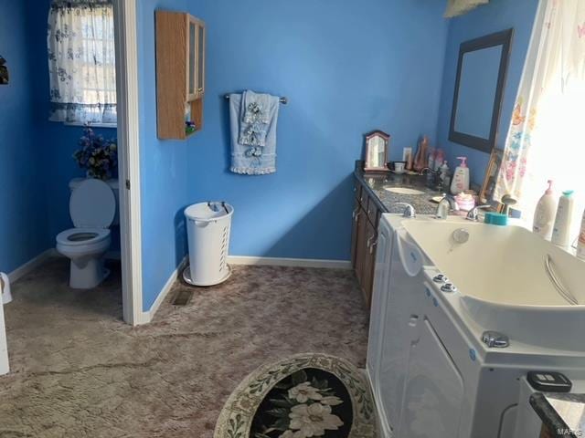 bathroom with toilet and vanity