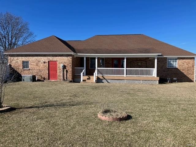 rear view of house featuring a lawn