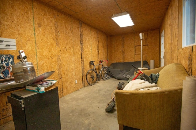 interior space with wooden walls and concrete flooring