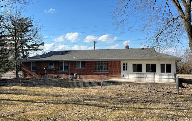 back of house featuring a lawn