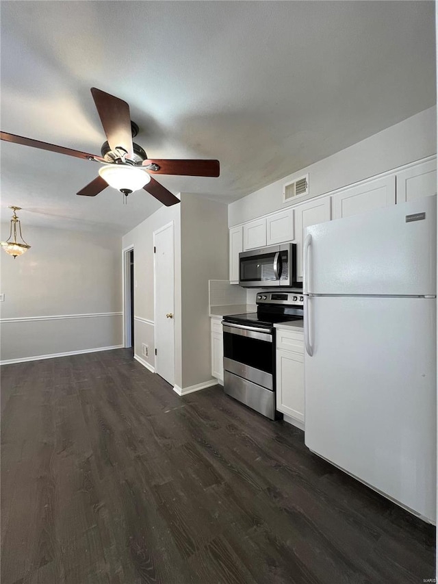 kitchen featuring ceiling fan, white cabinetry, dark wood-type flooring, and stainless steel appliances