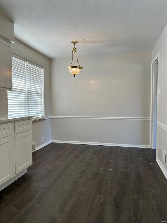 unfurnished dining area with dark hardwood / wood-style flooring