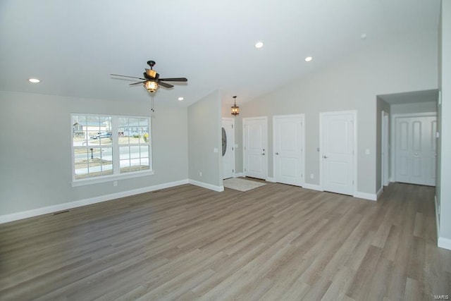 unfurnished living room featuring ceiling fan, high vaulted ceiling, and light hardwood / wood-style flooring