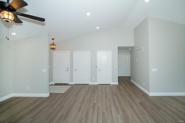 unfurnished living room featuring lofted ceiling, light hardwood / wood-style flooring, and ceiling fan