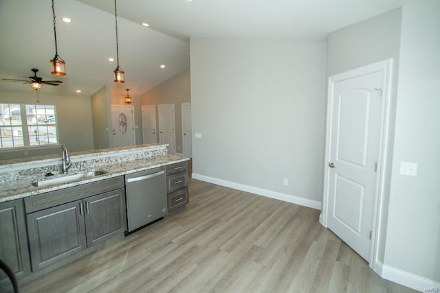 kitchen with dishwasher, sink, vaulted ceiling, light hardwood / wood-style floors, and ceiling fan