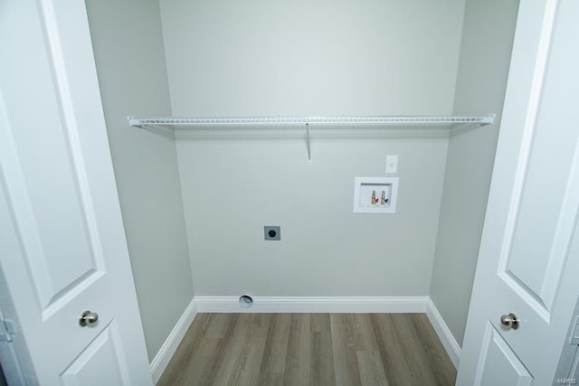 washroom featuring light hardwood / wood-style floors, hookup for an electric dryer, and washer hookup