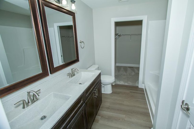 bathroom featuring vanity, wood-type flooring, and toilet