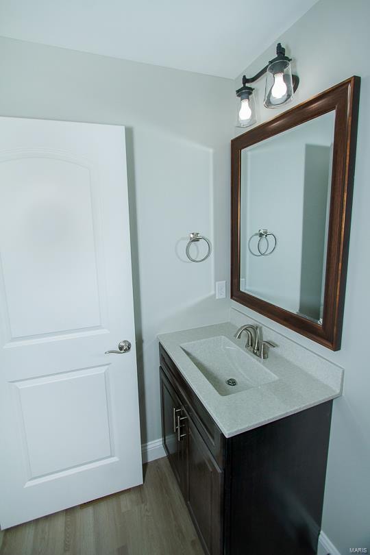 bathroom with vanity and hardwood / wood-style flooring