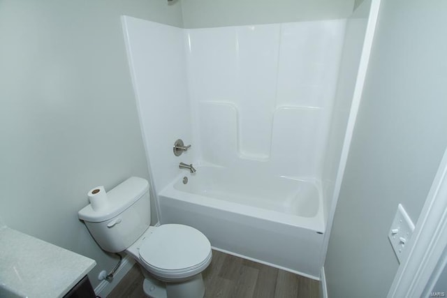 full bathroom with vanity, toilet, hardwood / wood-style flooring, and shower / bathtub combination