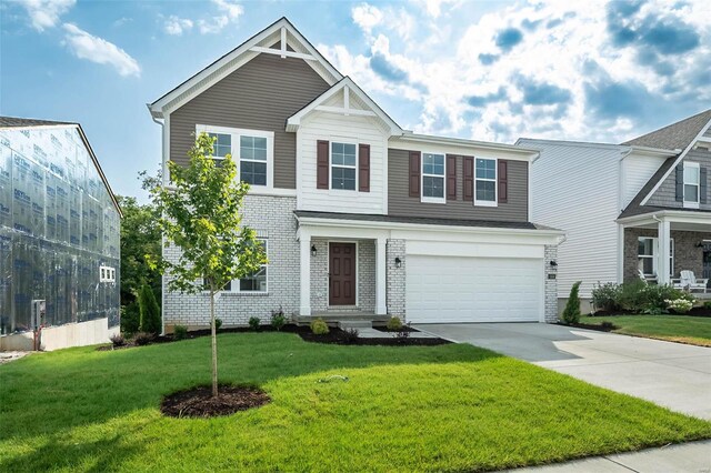 view of front of home featuring a front yard and a garage