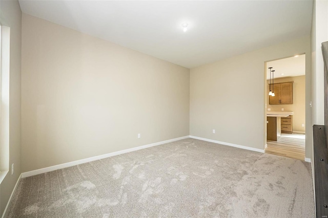 unfurnished room featuring baseboards and carpet flooring