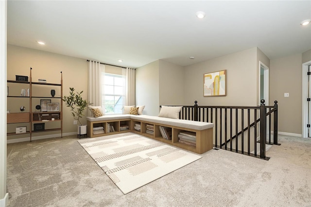 living area featuring baseboards, recessed lighting, an upstairs landing, and light colored carpet