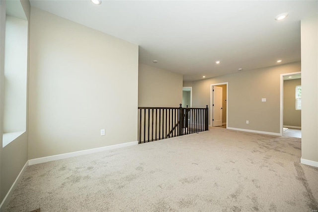 unfurnished room with baseboards, carpet floors, and recessed lighting