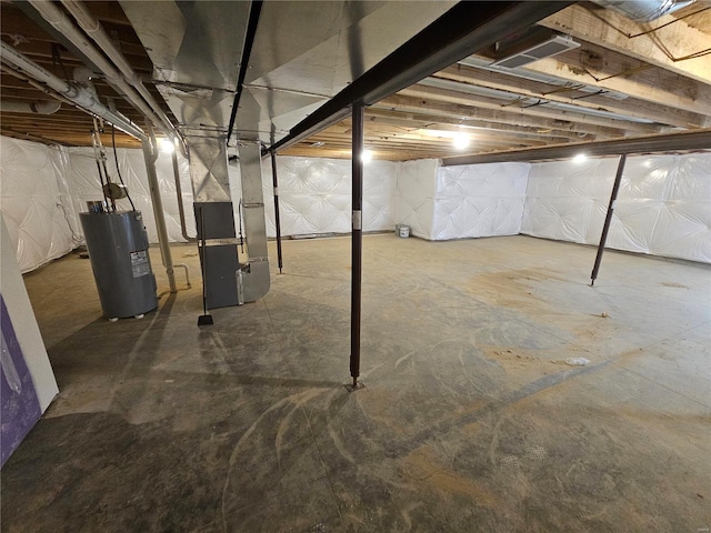 basement featuring electric water heater and heating unit