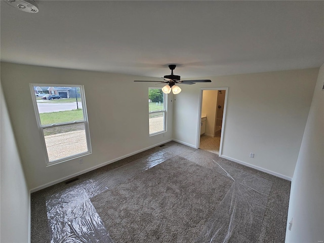 empty room featuring carpet flooring and ceiling fan