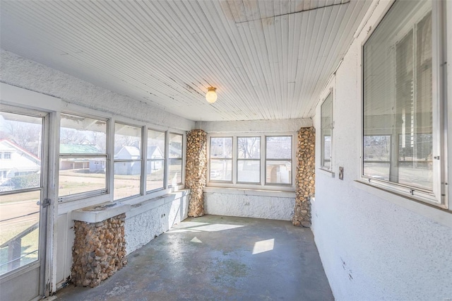 unfurnished sunroom with plenty of natural light