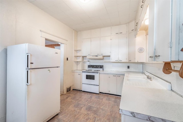 kitchen featuring tile flooring, white appliances, tasteful backsplash, and white cabinetry