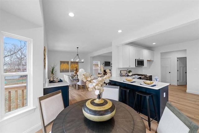 dining space featuring a chandelier and light hardwood / wood-style flooring