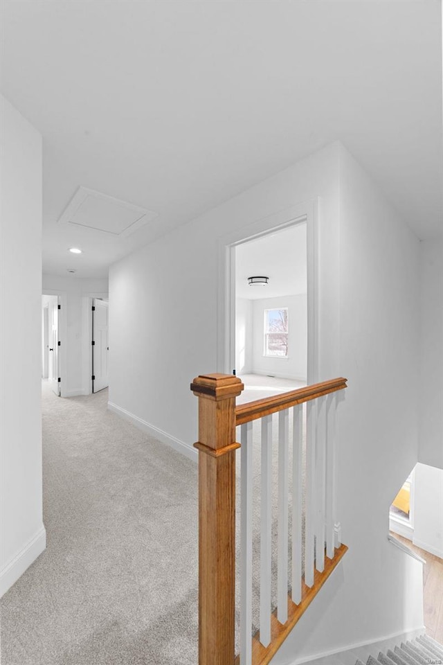 corridor featuring light colored carpet